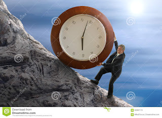 A man pushing a giant clock up a hillside